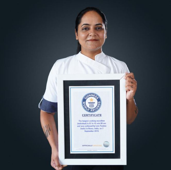 Chef Lata Tondon holding her Guinness World Record certificate for the 'Longest Cooking Marathon'. 
