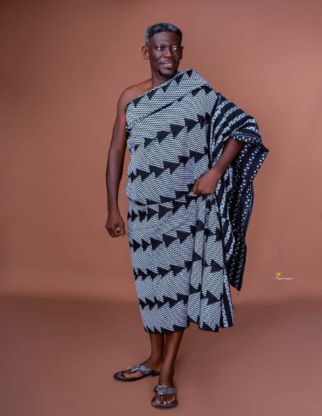 Agya Koo in a traditional outfit for a photoshoot. 
Image Source: Instagram: @real_agya_koo