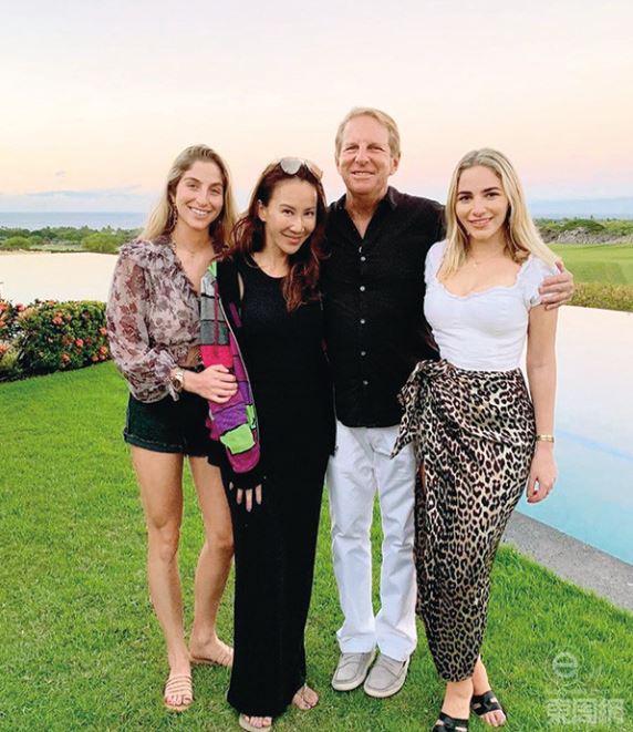 Coco Lee pictured with her stepdaughters and her husband. 
