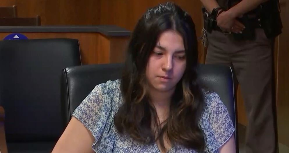 Megan Imirowicz seated as her brother Austin testifies against her about their father's death. Image Source: Courttv