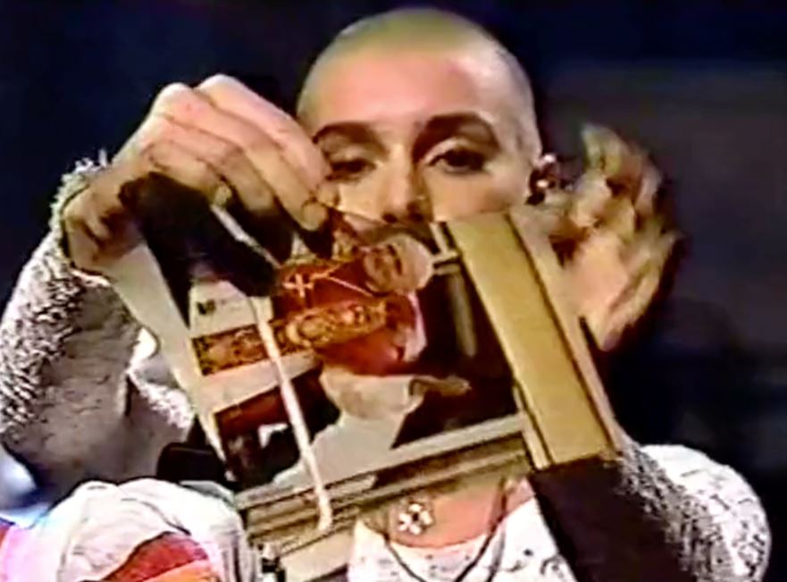 Image of Sinead O'Connor tearing up a photo of Pope John. Source: YouTube