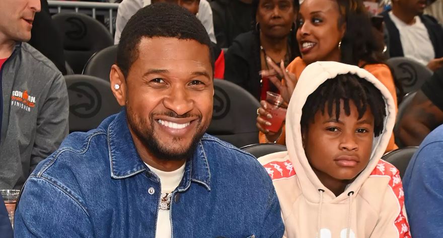 Usher Raymond and his son Usher Raymond V attend the game between Brooklyn Nets and the Atlanta Hawks at State Farm Arena on April 02, 2022 in Atlanta, Georgia