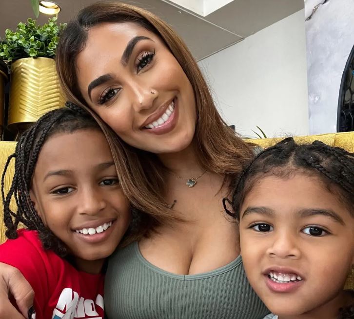 Queen Naija smiles and poses for a selfie with her sons CJ and Legend.