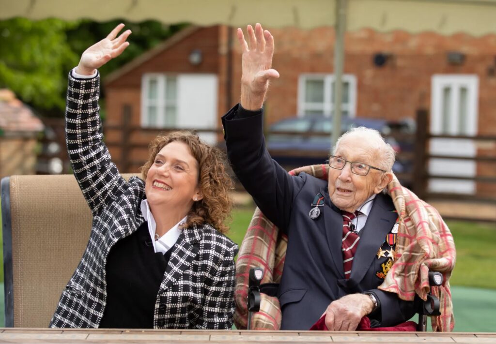 Tom and daughter Hannah during a RAF flypast to mark his 100th birthday last April Credit: EPA
