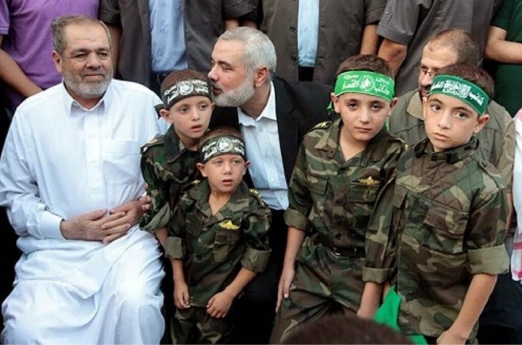 Ismail Haniyeh with the families of “martyrs.” Photo. Source: Algemeiner)