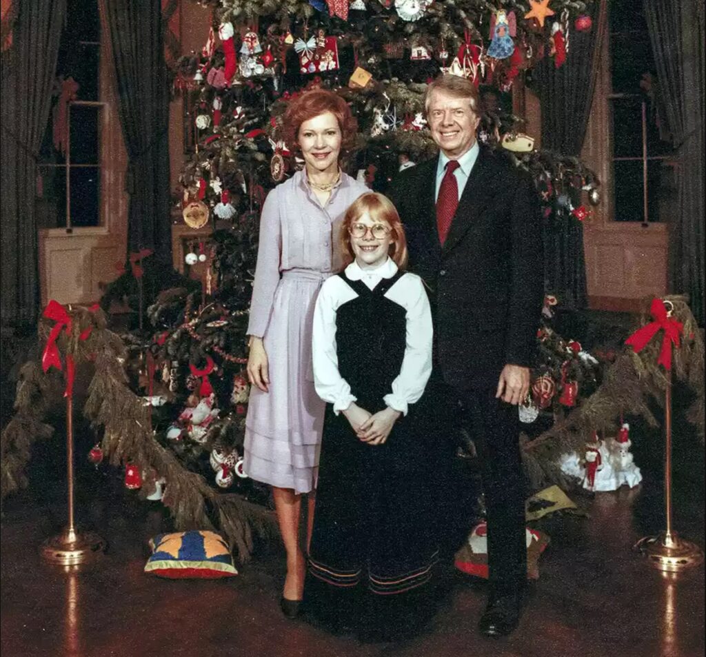 Portrait of the US First Family as they pose in front of the Christmas tree located in the Blue Room of the White House, Washington DC, December 20, 1977. Pictured are (rear) US First Lady Rosalynn Carter and President Jimmy Carter, with their daughter, Amy Carter. (Photo by Karl Schumacher - White House via CNP/Getty Images)
