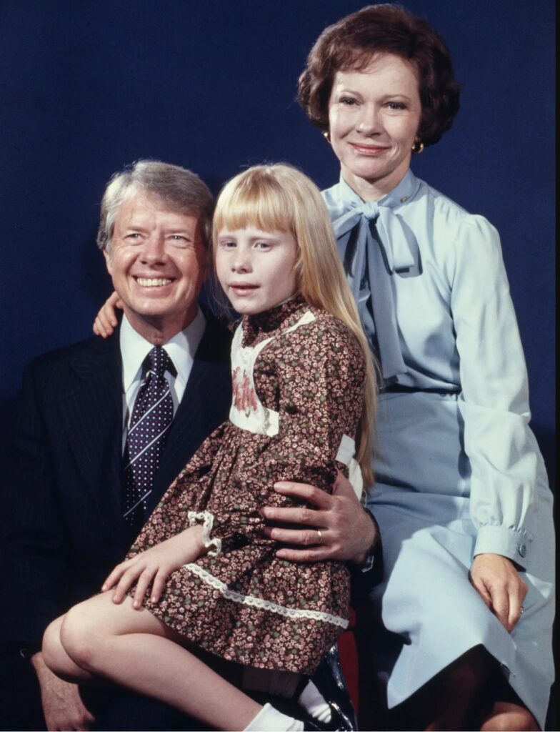 Jimmy Carter, his wife Rosalynn, and daughter Amy pose for an official family photograph in Plains, Georgia, December 5, 1976