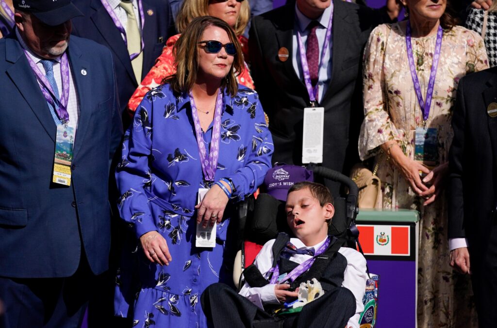 Cody's mum Leslie stands beside her boy after the whole family saw Cody's Wish win for the last time in the Breeders' Cup