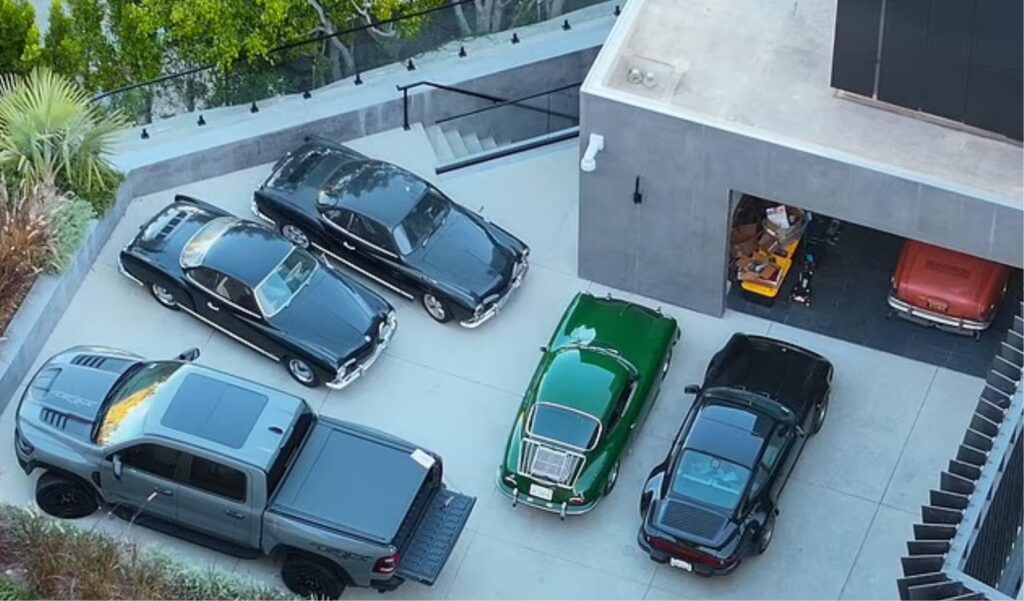 Edwin Castro's cars: From left, a Ram 1500 TRX, two black Volkswagen Karmann Ghias, and his two latest purchases, a green 1970s Porsche 911 SC and a black 1980s 911. A third, red Karmann Ghia can be seen in the garage