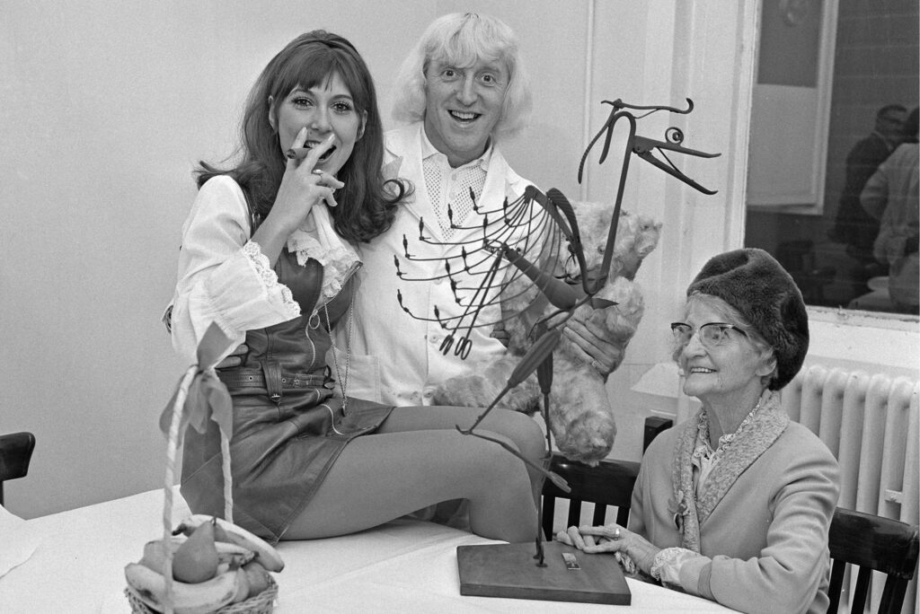 Jimmy Savile with actress Anita Harris and his mother Agnes on 5th November 1968. Daily Express /Hulton Archive/Getty Images
