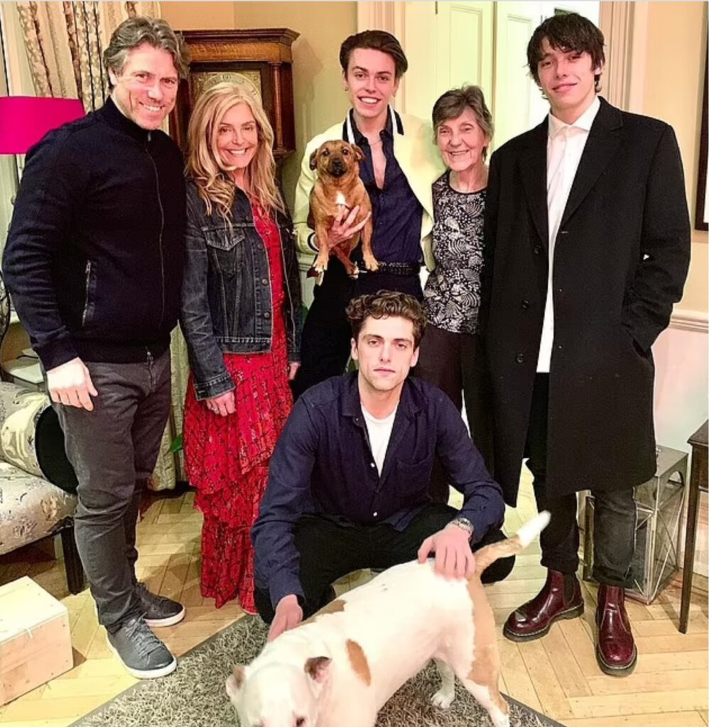 Family: The couple met at college in Manchester and married in 1993. They share sons Joe, 28, Luke, 26, and Daniel, 24, together (pictured with John's late mother Kathy, second right)

